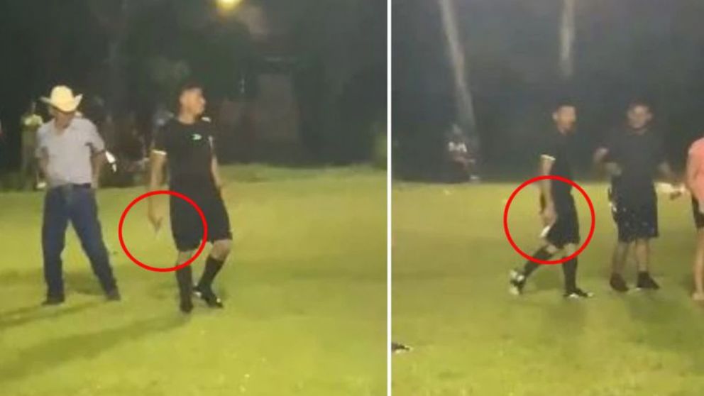 Un árbitro fue increpado por varios hinchas y sacó una arma de fuego para defenderse (imagen captura vídeo).