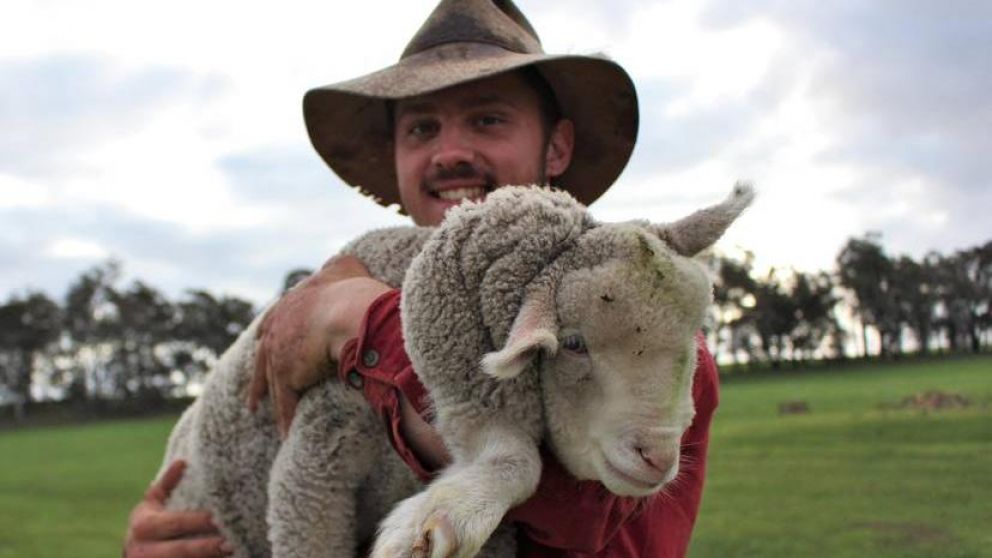 Marshall Bowey junto al pequeño Starfish, el cordero con cinco patas que nació en su granja (Gentileza Narrogin Observer).