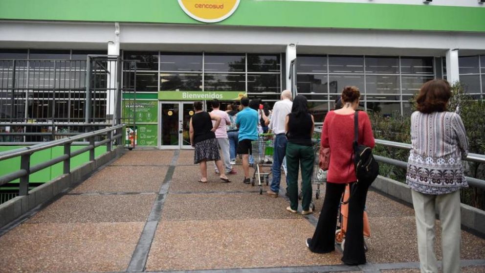 Así la gente espera para comprar en los supermercados porteños.