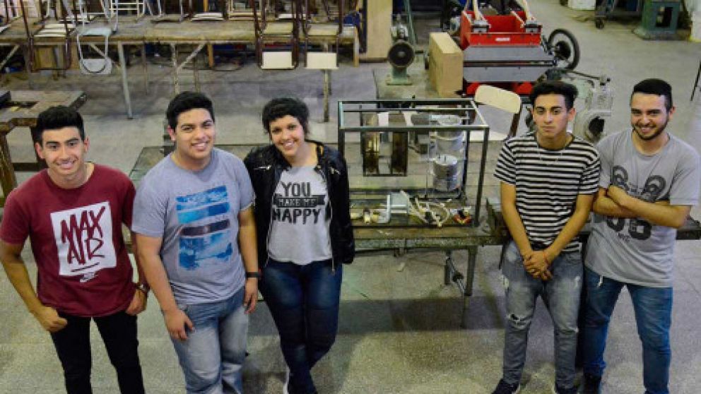 Los chicos, en el taller donde crearon la máquina para tomar mate.