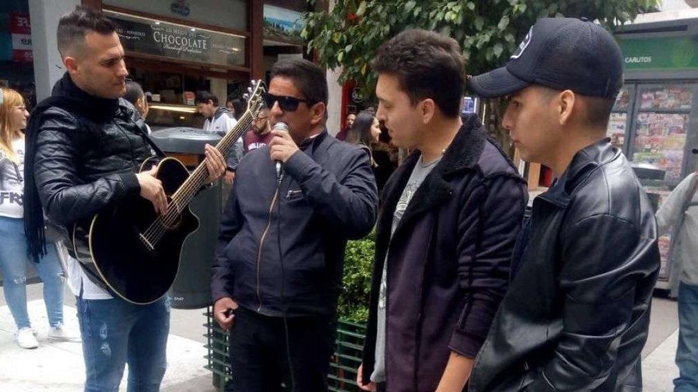 Banda XXI, cantando con un artista callejero. (Twitter)