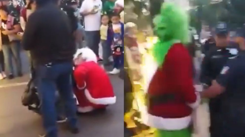 Dos hombres que trabajan en la calle disfrazados de Papá Noel y Grinch terminaron a las piñas por un insólito motivo (Captura video).